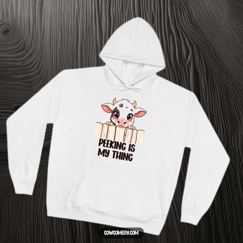Funny curious cow hoodie with a cow peeking over a fence, designed for warmth and a hint of mischief.